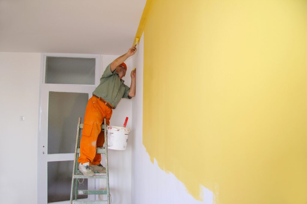 man painting interior wall